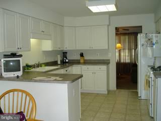 634 Surrey Road Sewell, NJ 08080 - Photo 3 of 4 a kitchen with stainless steel appliances granite countertop a sink stove and refrigerator