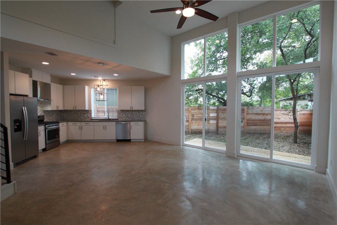 a view of a kitchen with a sink and a large window