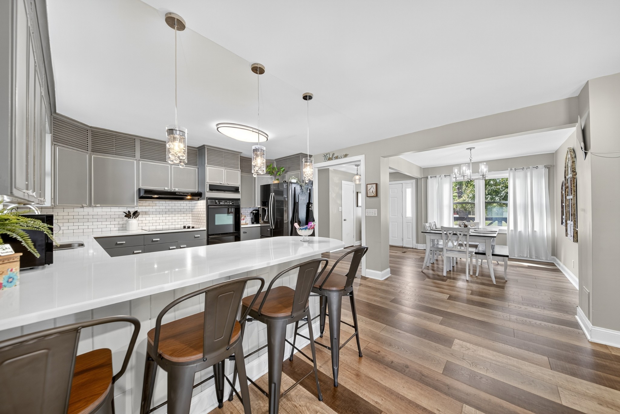 a large kitchen with a table and chairs