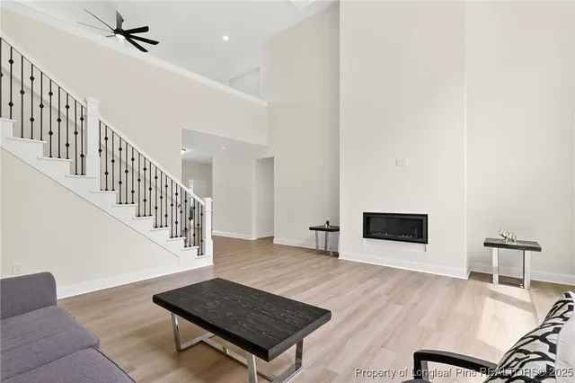 a living room with wooden floor and a rug