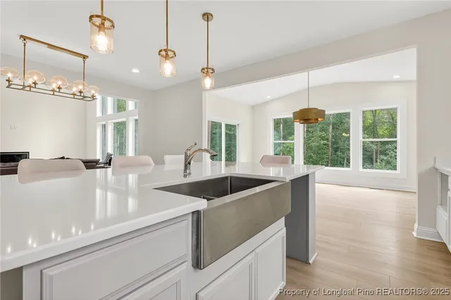 a kitchen with a sink appliances and a large window