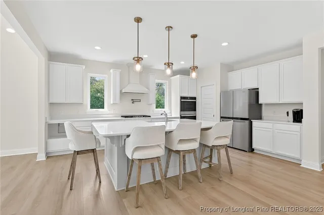 a large kitchen with a table and chairs