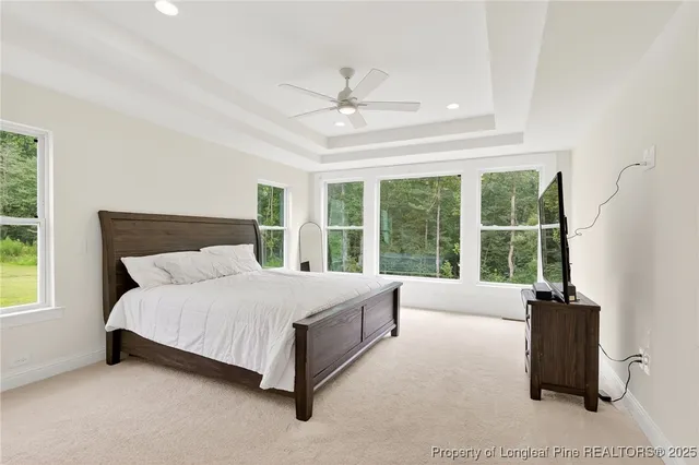 a large bed sitting in a bedroom next to a window