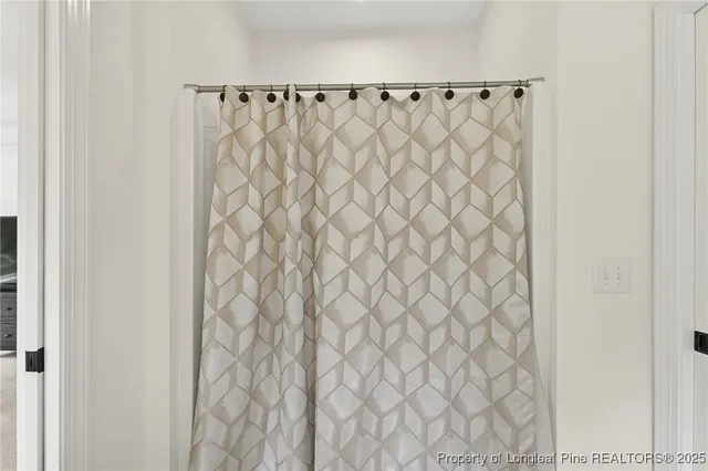 a bathroom with a shower curtain and curtain
