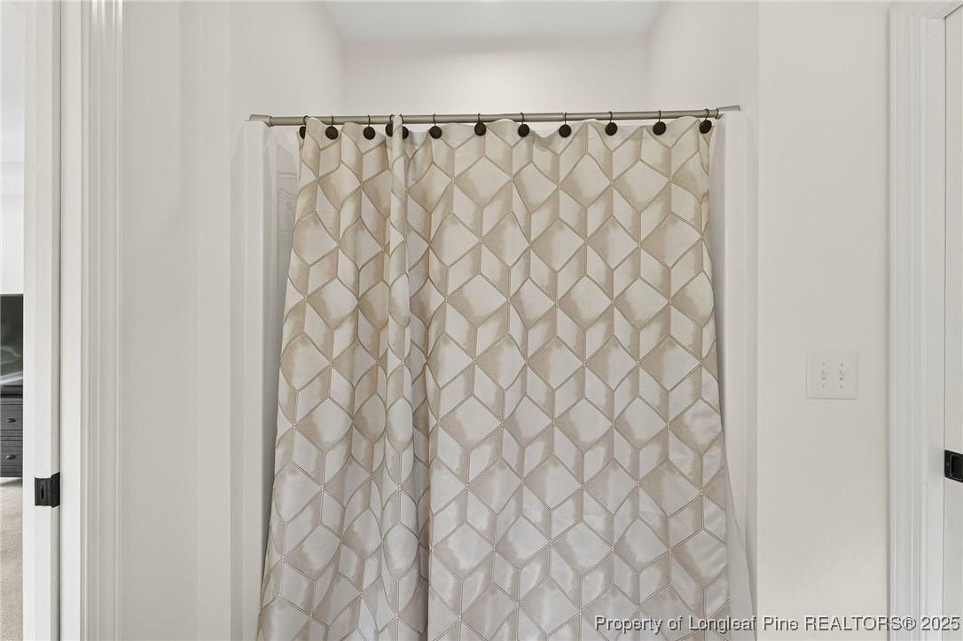 197 Silverside Drive Angier, NC 27501 - Photo 26 of 48 a bathroom with a shower curtain and curtain