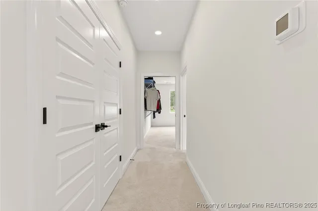 a hallway with white doors