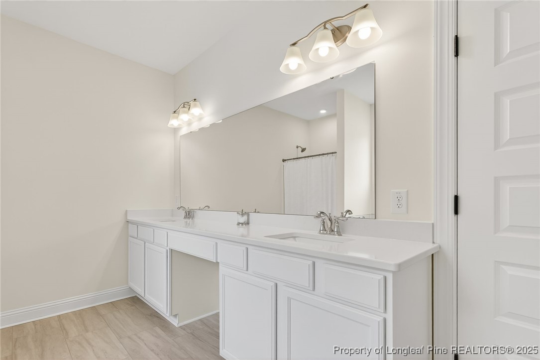 197 Silverside Drive Angier, NC 27501 - Photo 32 of 48 a bathroom with a double vanity sink and a mirror