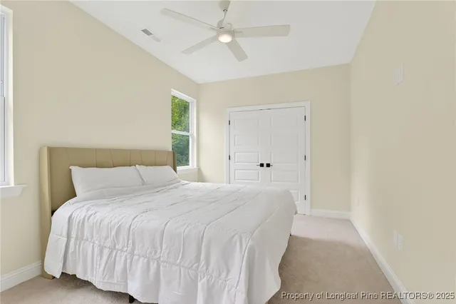a bedroom with a bed and a ceiling fan