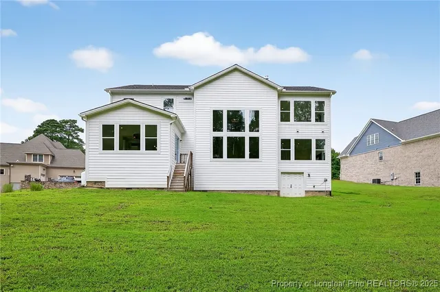 a view of a house with a yard and porch