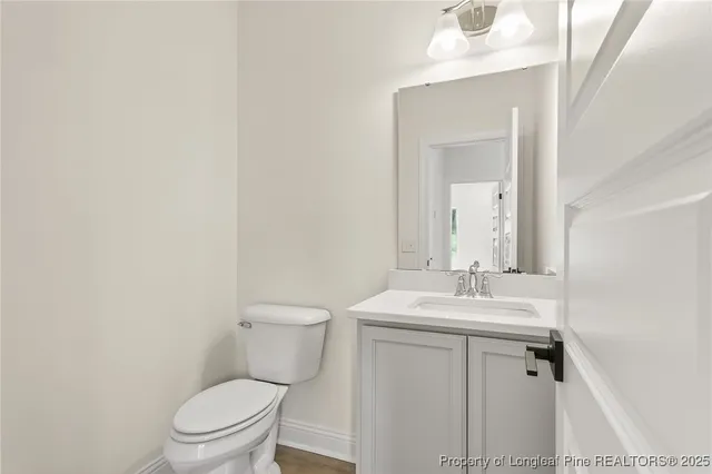 a bathroom with a sink toilet and mirror