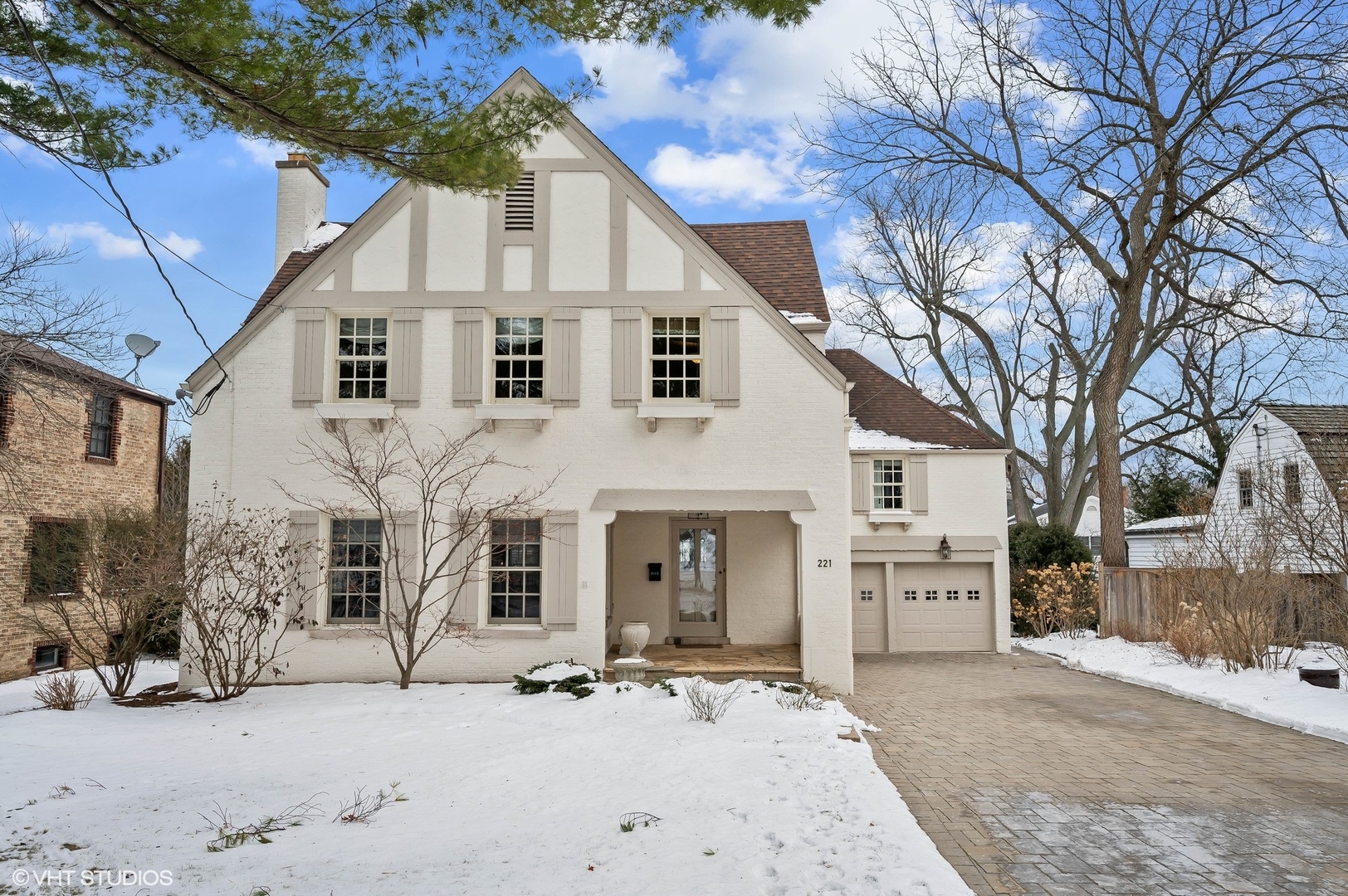 221 Church Road Winnetka, IL 60093 - Photo 2 of 42 a white house with a large tree in front of it