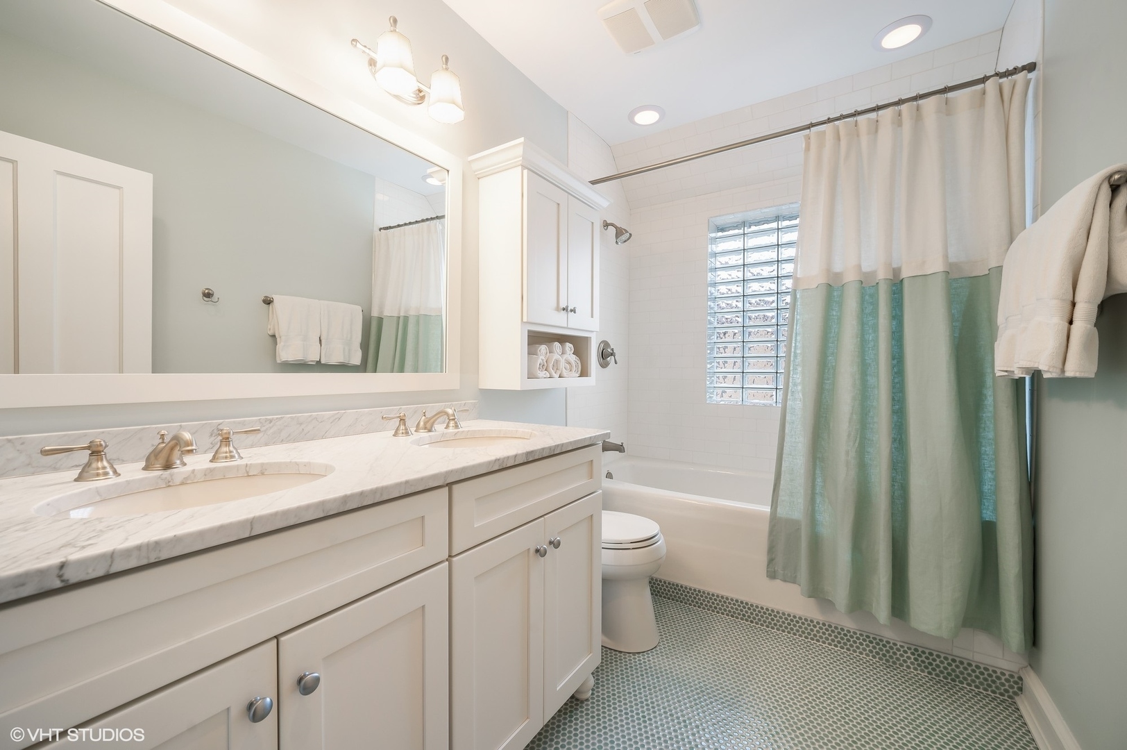 221 Church Road Winnetka, IL 60093 - Photo 29 of 42 a spacious bathroom with a double vanity sink toilet mirror and bathtub