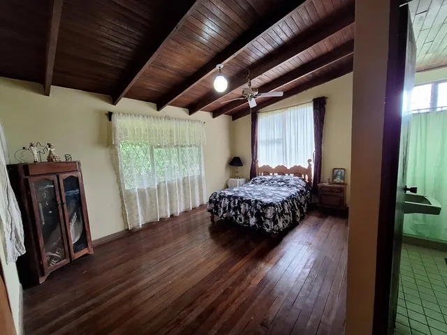 a bedroom with a bed closet and a window