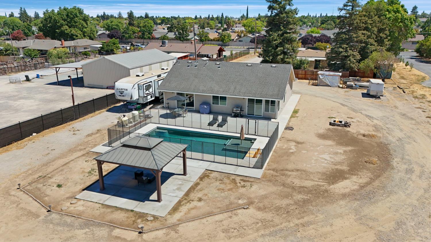 23811 South Jack Tone Road Ripon, CA 95366 - Photo 12 of 51 an aerial view of a house with swimming pool and large trees