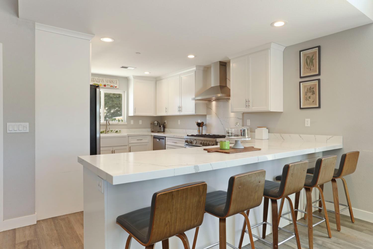 23811 South Jack Tone Road Ripon, CA 95366 - Photo 16 of 51 a kitchen with a dining table chairs and white cabinets