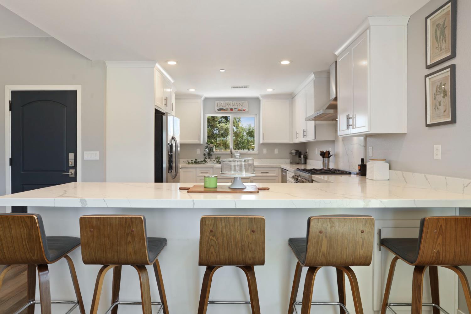 23811 South Jack Tone Road Ripon, CA 95366 - Photo 17 of 51 a kitchen with stainless steel appliances granite countertop a table chairs and a refrigerator