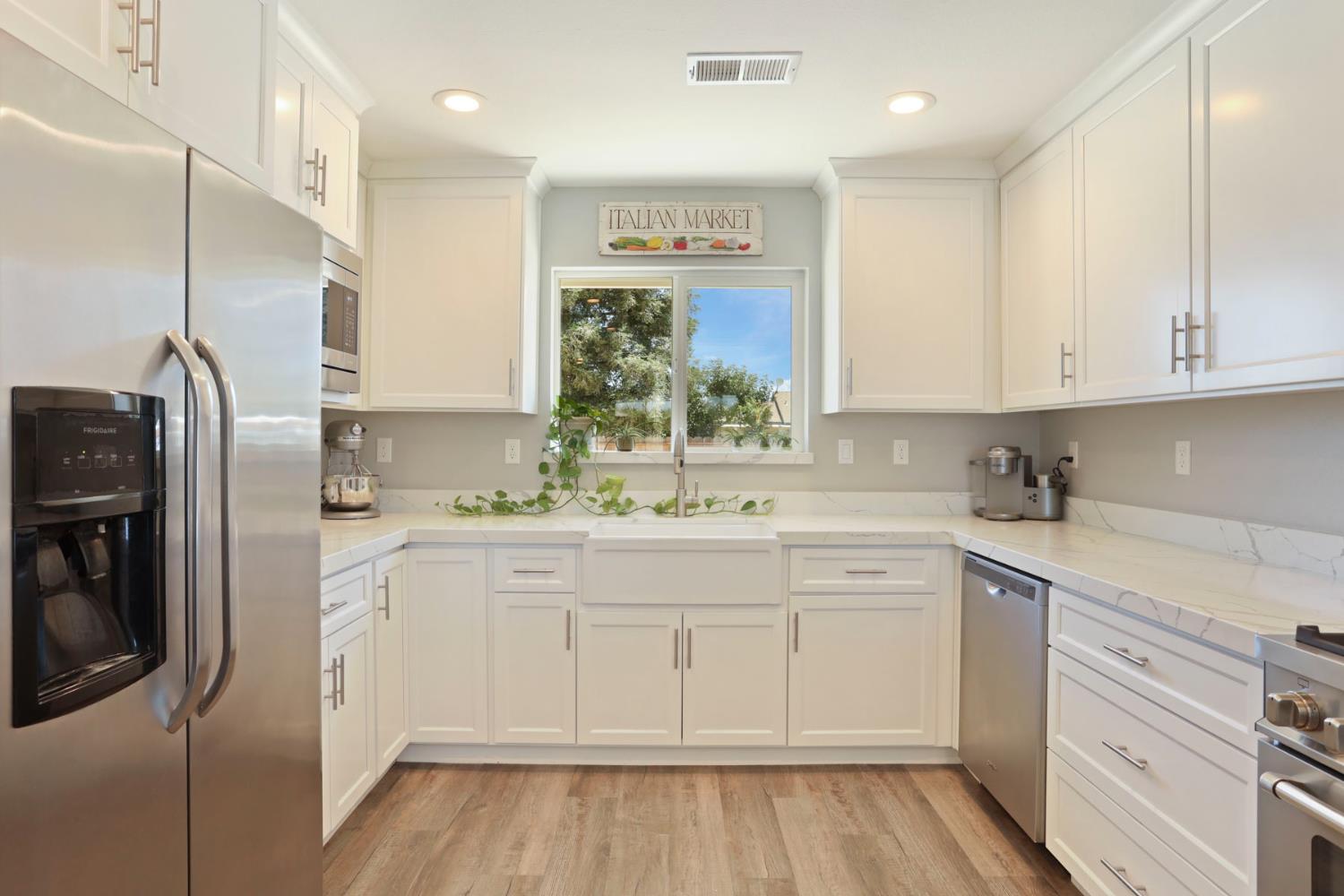 23811 South Jack Tone Road Ripon, CA 95366 - Photo 20 of 51 a kitchen with white cabinets and stainless steel appliances