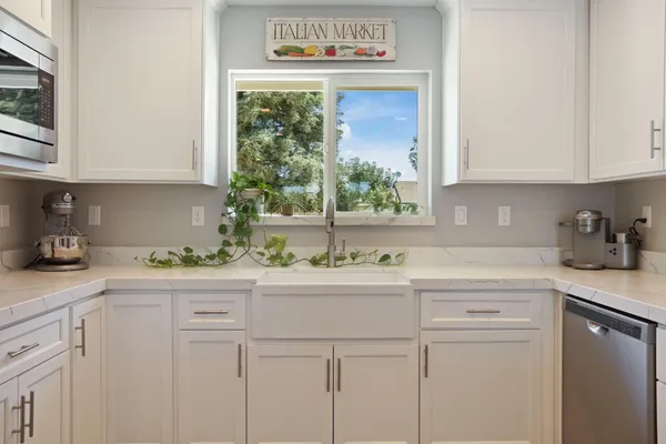 a kitchen with stainless steel appliances a stove a sink and a refrigerator
