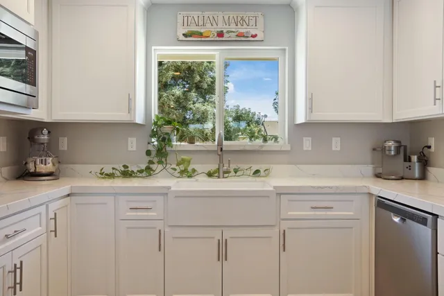 a kitchen with stainless steel appliances a stove a sink and a refrigerator