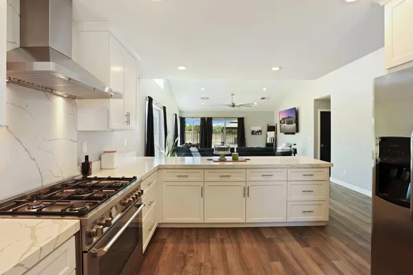 a stove top oven sitting inside of a kitchen