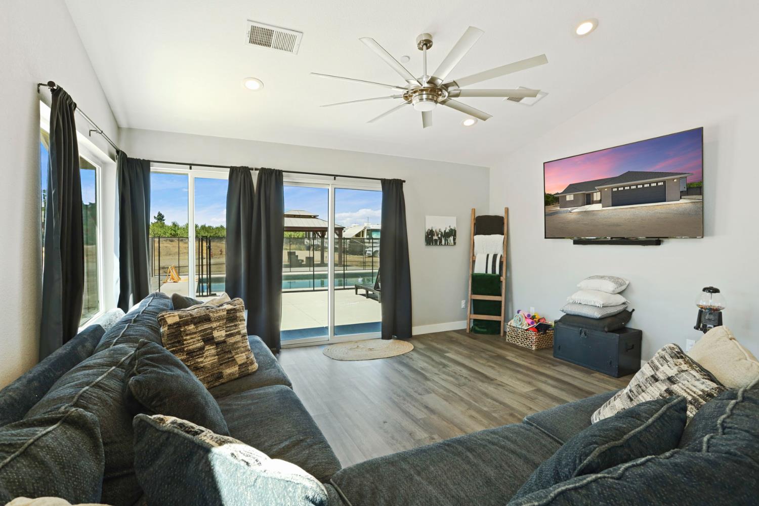 23811 South Jack Tone Road Ripon, CA 95366 - Photo 25 of 51 a living room with furniture and a flat screen tv