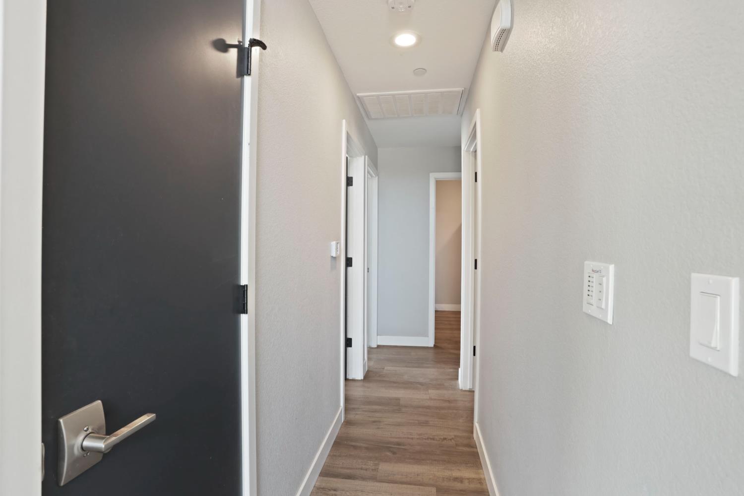 23811 South Jack Tone Road Ripon, CA 95366 - Photo 27 of 51 a view of a hallway with wooden floor