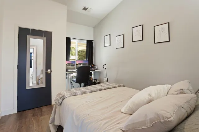 a bedroom with a bed and a window