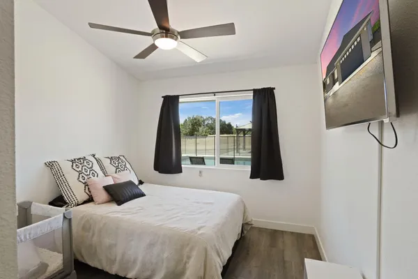 a bedroom with a bed and night stand