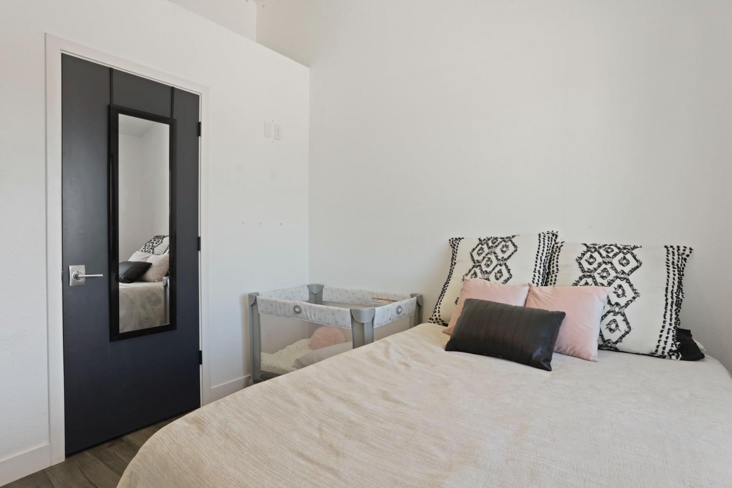 23811 South Jack Tone Road Ripon, CA 95366 - Photo 30 of 51 a bedroom with a bed and night stand