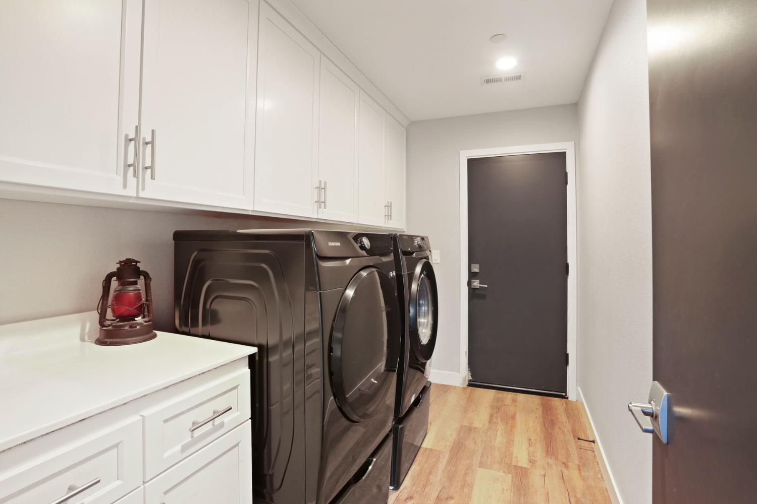 23811 South Jack Tone Road Ripon, CA 95366 - Photo 31 of 51 a utility room with cabinets washer and dryer