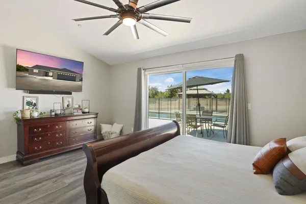a bedroom with a bed and a flat screen tv
