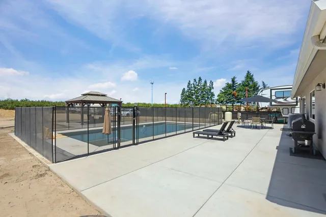 a swimming pool with outdoor seating