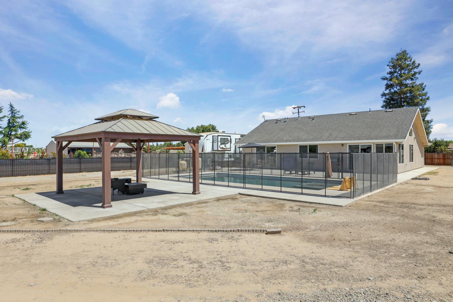23811 South Jack Tone Road Ripon, CA 95366 - Photo 45 of 51 a backyard of a house with portable swimming pool and outdoor seating