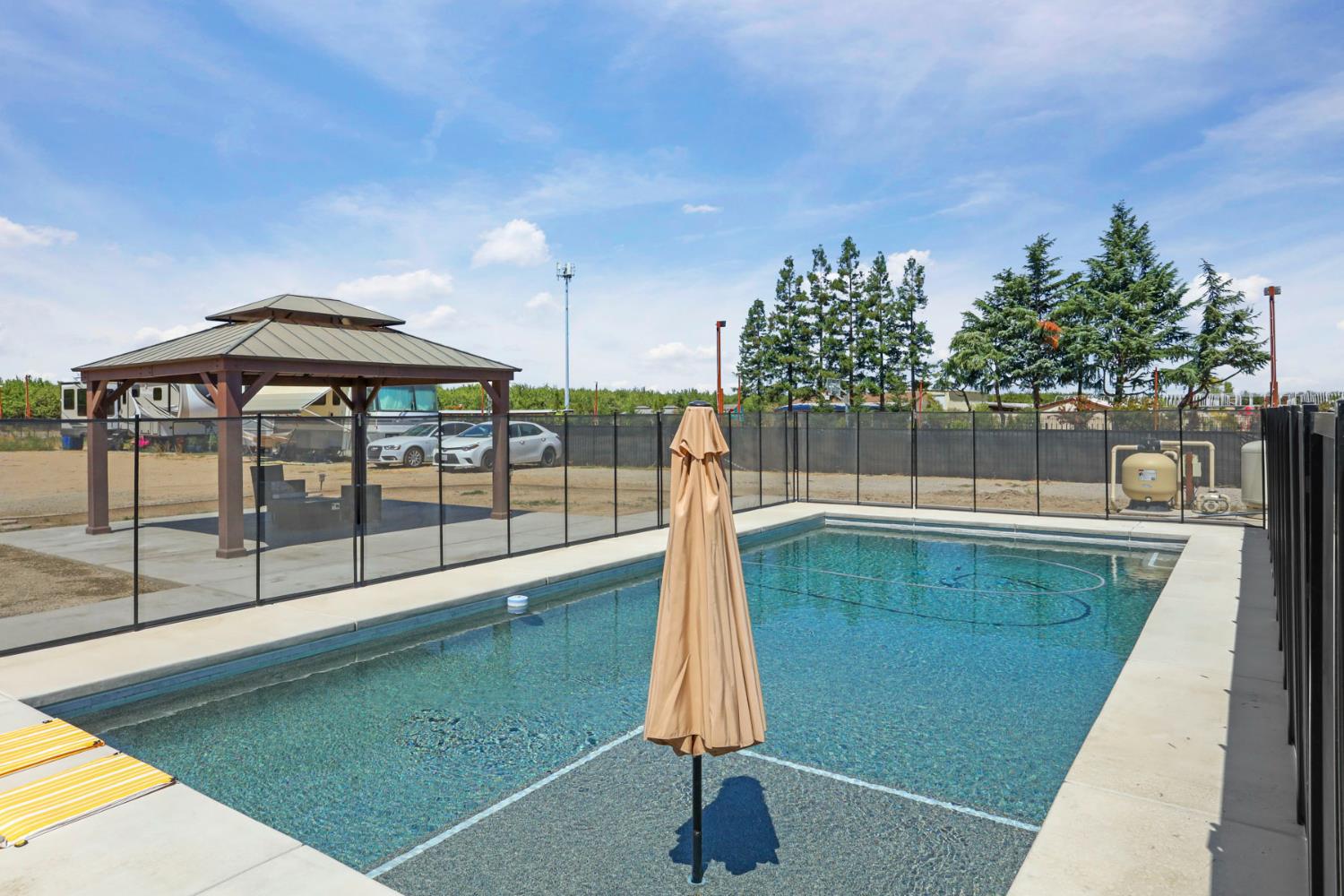 23811 South Jack Tone Road Ripon, CA 95366 - Photo 47 of 51 a swimming pool with outdoor seating and yard