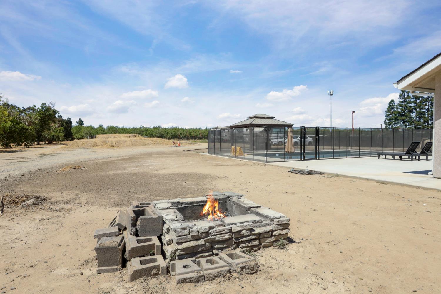 23811 South Jack Tone Road Ripon, CA 95366 - Photo 5 of 51 a view of swimming pool with lawn chairs and iron fence