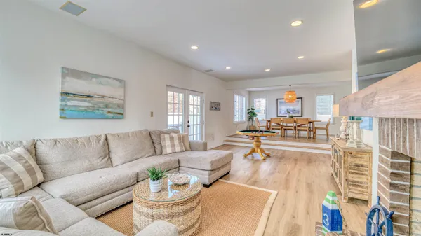 a view of a livingroom with furniture a dinning table and chairs