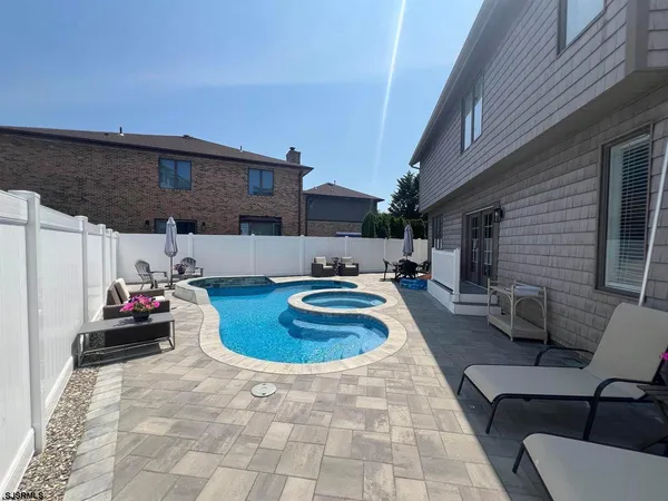 a swimming pool view with a seating space