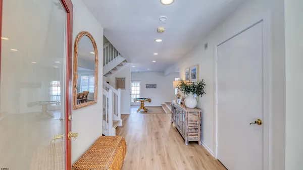 a bedroom with a bed next to a window and a chandelier