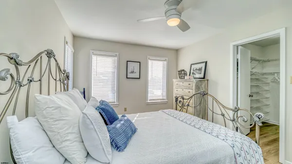 a spacious bedroom with two beds and a chair