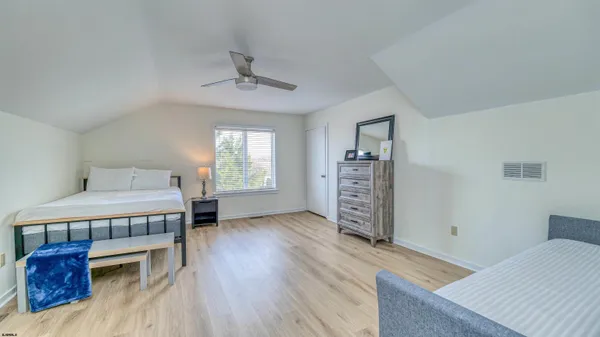 a bedroom with a bed and a night stand