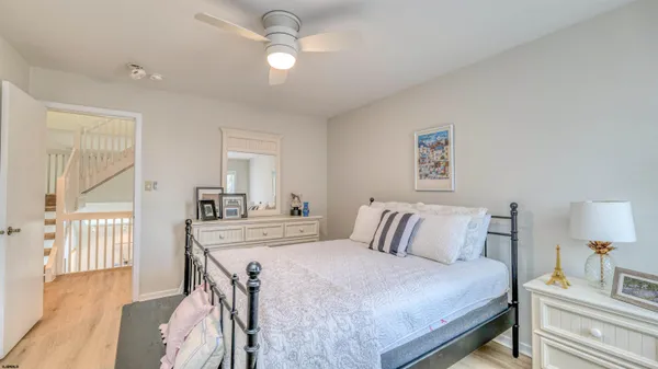 a bathroom with a granite countertop sink mirror vanity and toilet