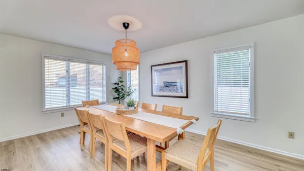 a living room with dining table furniture and a chandelier