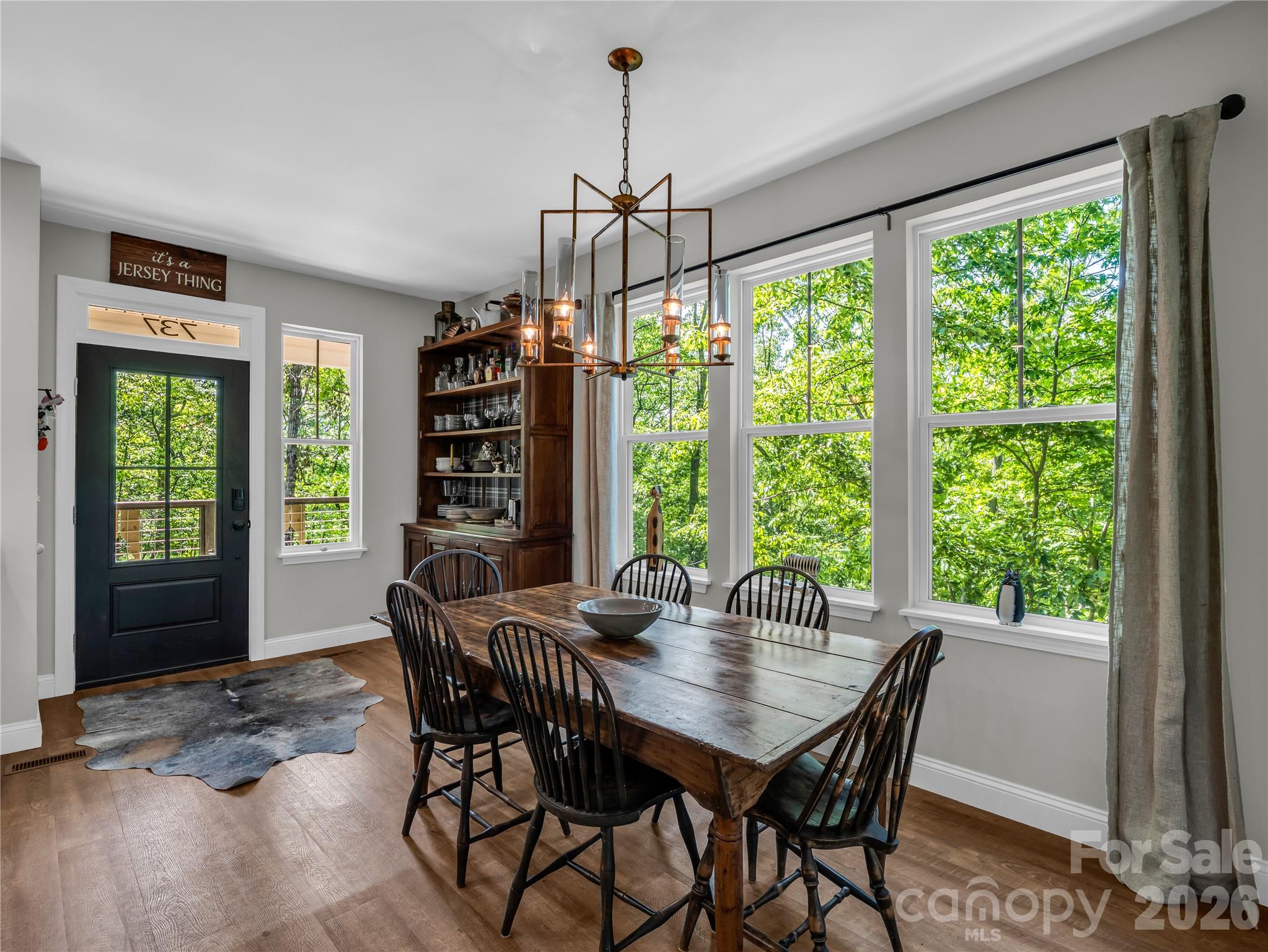 737 Melrose Mountain Road Tryon, NC 28782 - Photo 18 of 42 a dining room with furniture window wooden floor