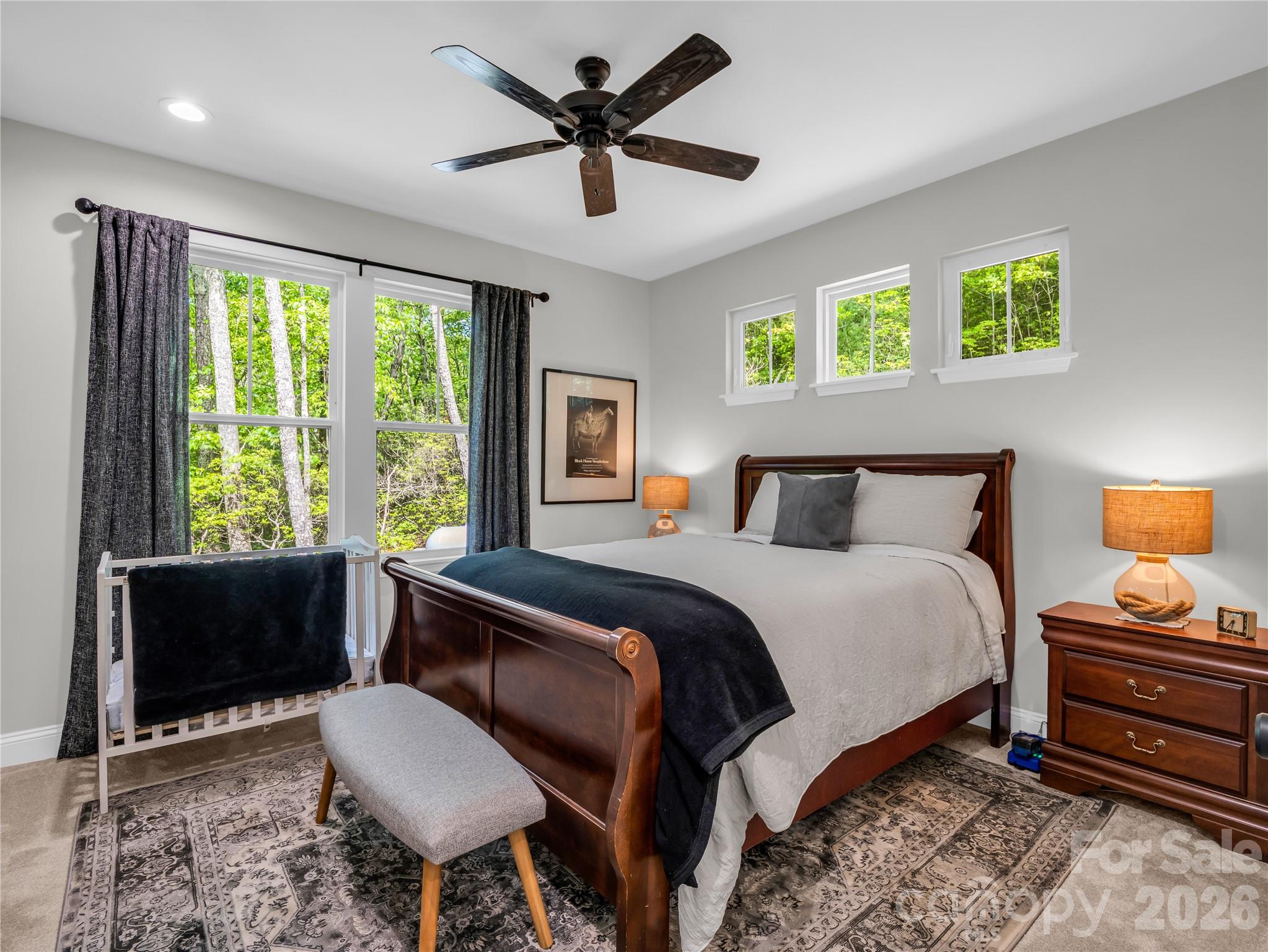 737 Melrose Mountain Road Tryon, NC 28782 - Photo 23 of 42 a bedroom with a bed and a chandelier
