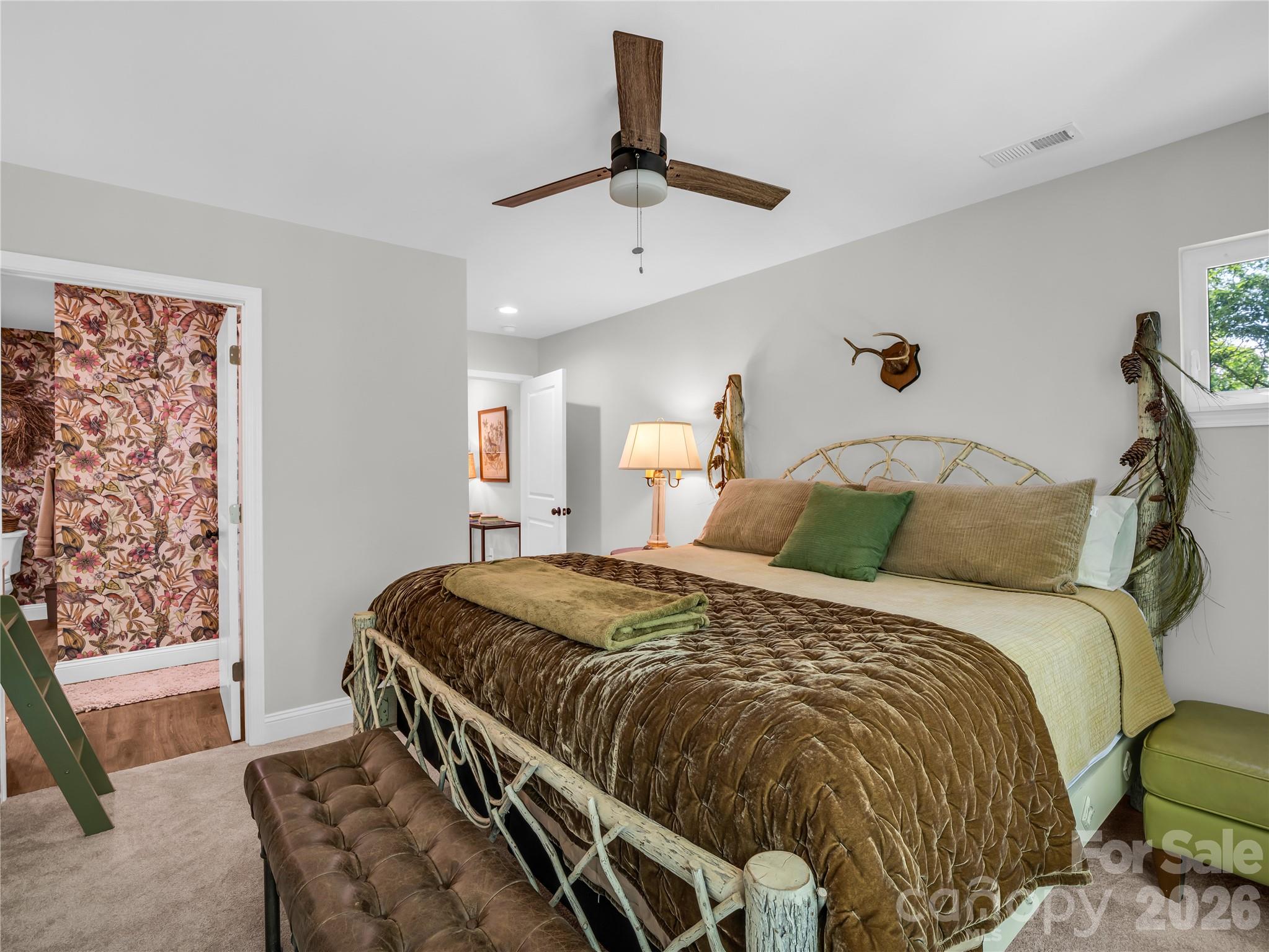 737 Melrose Mountain Road Tryon, NC 28782 - Photo 27 of 42 a bed sitting in a bedroom next to a window