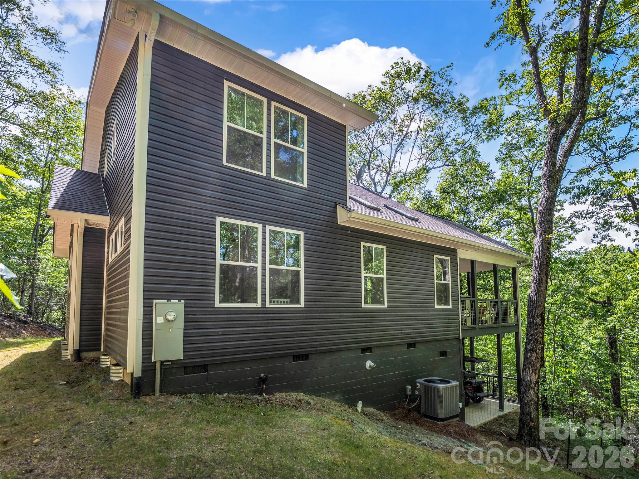 737 Melrose Mountain Road Tryon, NC 28782 - Photo 6 of 42 a view of a house with a yard and plants