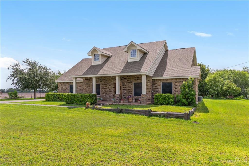 605 South Whalen Road Donna, TX 78537 - Photo 2 of 21 Brick and stone facade residence featuring a covered front porch with four columns