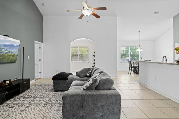 a living room with furniture and a chandelier