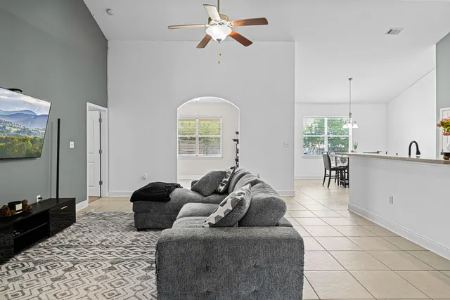 a living room with furniture and a chandelier