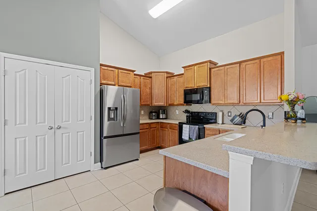 a kitchen with a refrigerator stove and sink